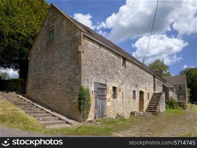 Old stone-built Cotswold barn with dovecote, Hazelton, Gloucestershire, England.
