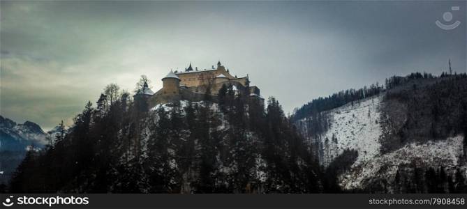 Old stone castle standing on high mountain at Austrian Alps