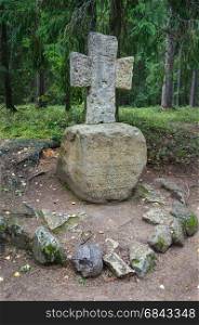 Old stone cross by the path to the village of Mikhailovskoye, the estate of Pushkin's parents. Pskov region, Russia