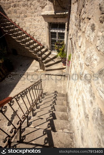 Old stone double staircase at backyard of ancient house