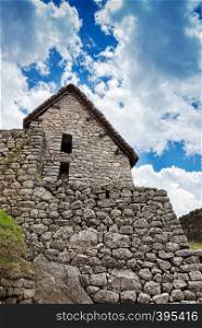 old stone house and wall in Machu Picchu