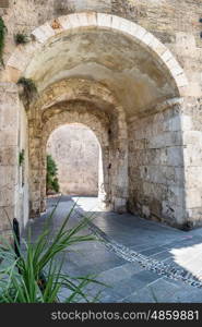 Old stone passage in the stone wall of an european city