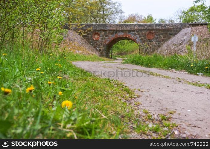 old stone viaduct, an arched railway bridge over the road. an arched railway bridge over the road, old stone viaduct