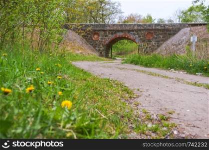 old stone viaduct, an arched railway bridge over the road. an arched railway bridge over the road, old stone viaduct