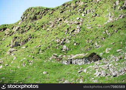 Old stones house in mountain. Old stones house on Mykines on the Faroe Islands in mountain