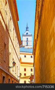 Old street and one of towers of Alcasar in Toledo, Spain