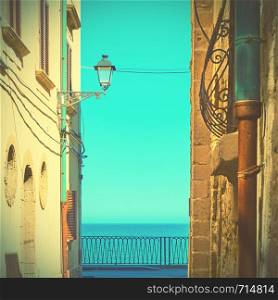 Old street by the sea in Ortygia in Syracuse, Italy. Retro-vintage social media style toning