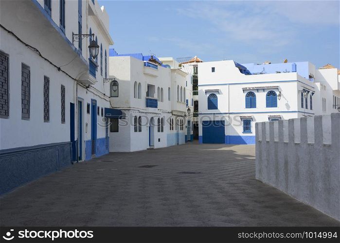 Old street in the medina of Asilah with at one side the stone rampart to the beach