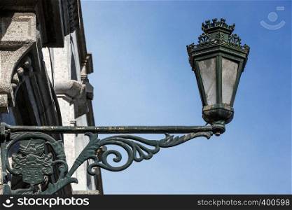 old street lamp on the wall of a building