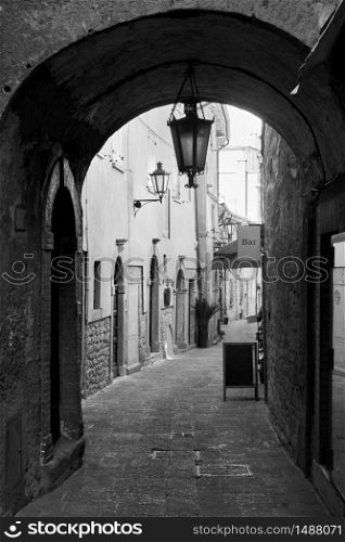Old street with archway in San Marino - Black and white cityscape
