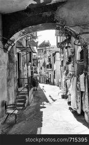 Old street with dilapidated houses in Catania, Sicily, Italy. Black and white image