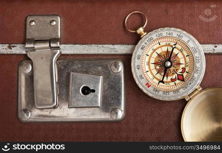 old suitcase and compass isolated on white background