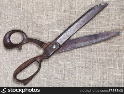 old tailor shears on textile background