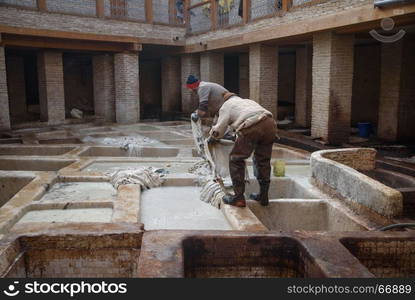 Old tannery in Fez, Morocco. Tannery in the middle of souk in Fez, Morocco. Traditional leather tannery from the 11th century is now biggest tourits attraction in Fes.