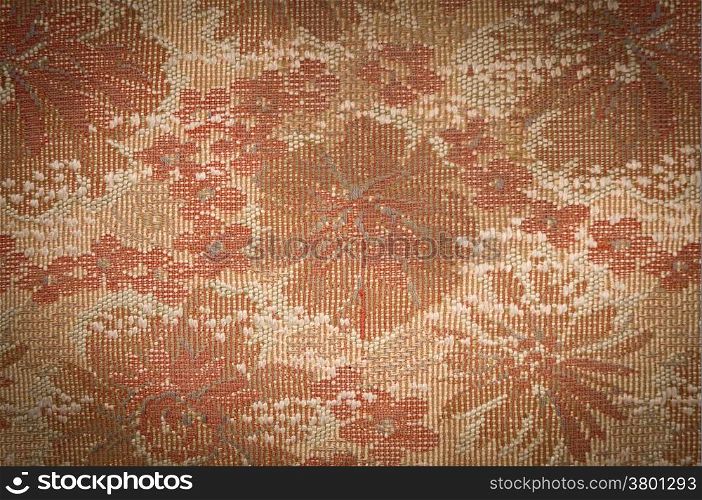 Old Tapestry fabric tinted sepia with vignetting effect as background