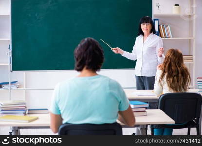 Old teacher and students in the classroom 