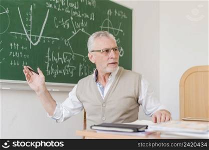 old teacher explaining lecture room