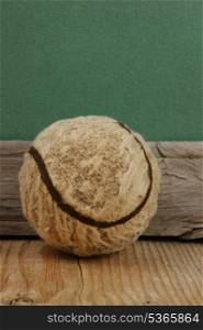 old tennis ball on a wooden floor