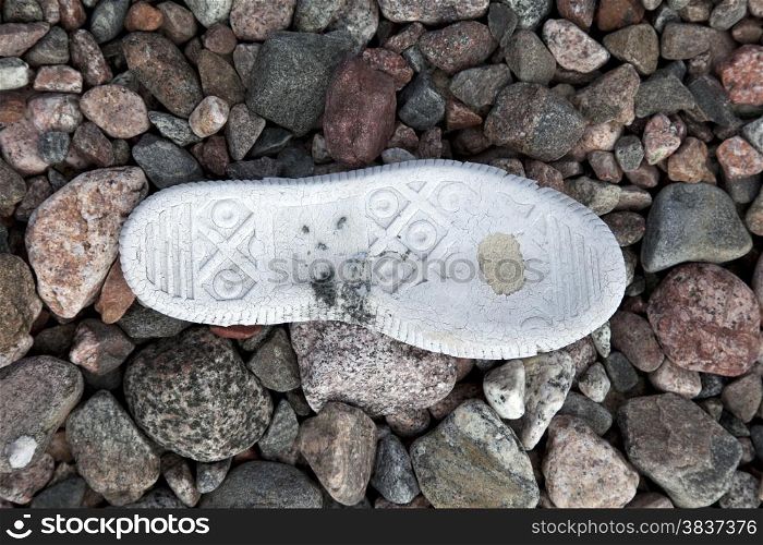 Old tennis shoe on the stone background