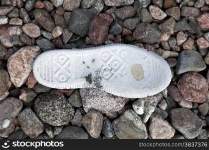 Old tennis shoe on the stone background
