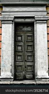old terrible door with cracked columns