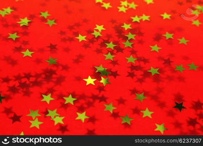 Old textured red holiday background with a gold stars