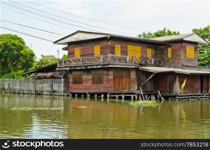 Old Thai wooden house along canal