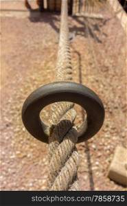 Old thick rope with a rusty ring