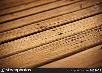 Old timber decking showing its age with nails lifting