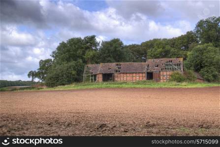 Old timber-frame and brick barn, Warwickshire, England.