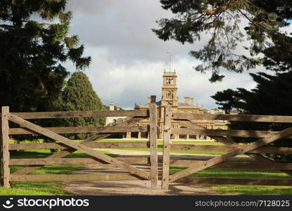 old timber hardwood farm gate in the native gardens out the front of heritage Werribee mansion, Werribee Victoria, Australia