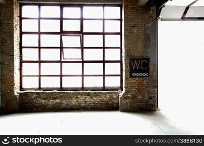 Old toilet sign hanging on abandoned factory