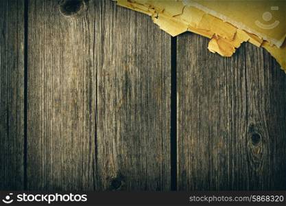 Old torn paper on wood planks background