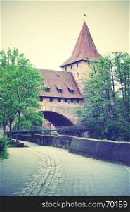 Old tower and bridge in Nuremberg, Germany. Retro style filtered image