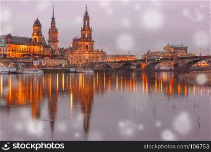 Old Town and Elba at night in Dresden, Germany. Dresden Cathedral of the Holy Trinity or Hofkirche, Bruehl's Terrace or The Balcony of Europe, Semperoper and Augustus Bridge with reflections in the river Elbe at snowy christmas night in Dresden, Saxony, Germany
