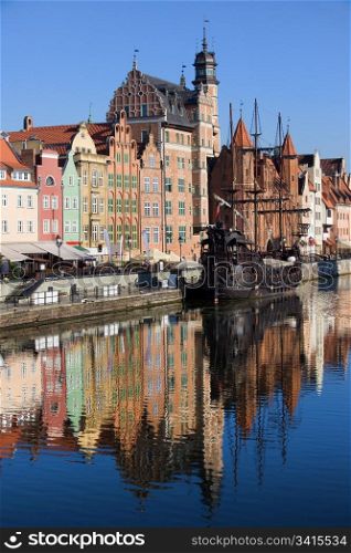 Old Town houses waterfront architecture with reflections on Motlawa river waters in the city of Gdansk (Danzig), Poland