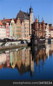 Old Town houses waterfront architecture with reflections on Motlawa river waters in the city of Gdansk (Danzig), Poland