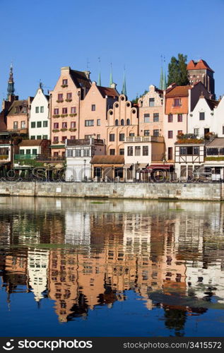 Old Town houses waterfront architecture with reflections on Motlawa river waters in the city of Gdansk (Danzig), Poland