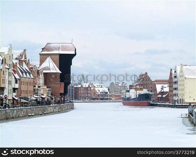Old Town of Gdansk (Danzig) in Poland with Motlava river and the Crane (Polish: Zuraw). Winter scenery