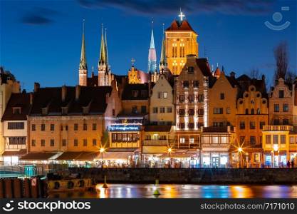 Old Town of Gdansk, Dlugie Pobrzeze, Bazylika Mariacka or St Mary Church, City hall and Motlawa River at night, Poland. Old Town and Motlawa River in Gdansk, Poland