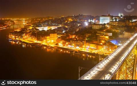 Old Town of Porto at night. Famous Dom Luis I bridge on the foreground