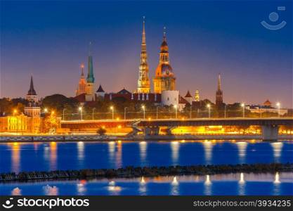 Old Town of Riga and River Daugava at night, Riga Cathedral, Saint Peter church and Riga castle in the background, Latvia