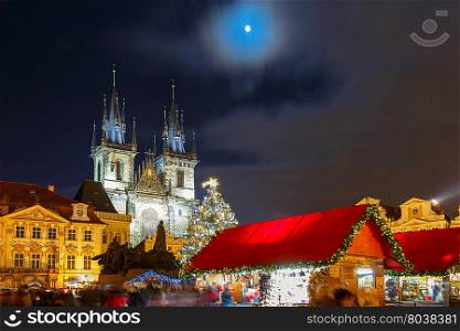 Old Town Square with Christmas market, tree and fairy tale Church of our Lady Tyn in the magical city of Prague at night, Czech Republic