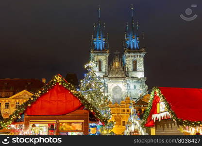 Old Town Square with Christmas market, tree and fairy tale Church of our Lady Tyn in the magical city of Prague at night, Czech Republic