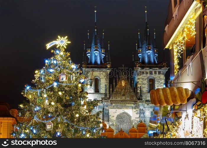 Old Town Square with Christmas tree and fairy tale Church of our Lady Tyn in the magical city of Prague at night, Czech Republic
