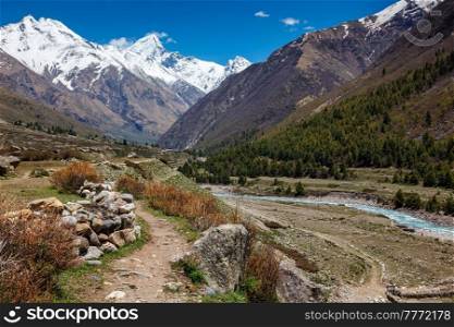 Old trade route in Himalaya surrounded with stones to Tibet from Chitkul village from Sangla Valley. Himachal Pradesh, India. Old trade route to Tibet from Sangla Valley. Himachal Pradesh, India