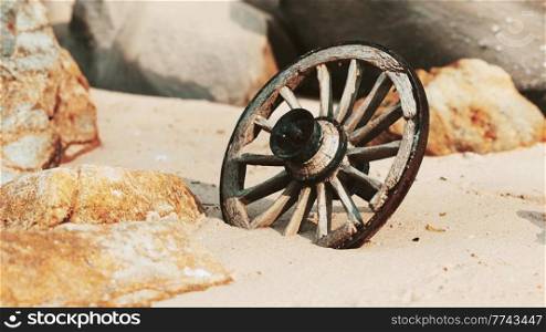 old tradition waggon wheel on the sand