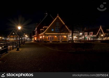 Old traditional dutch wooden houses in Friesland the Netherlands by night in christmas time