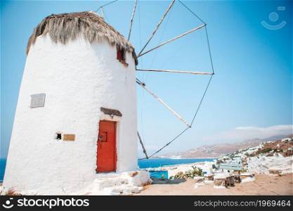 Old traditional greek windmills on Mykonos island at sunrise, Cyclades, Greece. Old traditional windmills over the town of Mykonos.