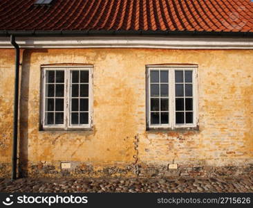 old traditional house in denmark with ocre colour wall